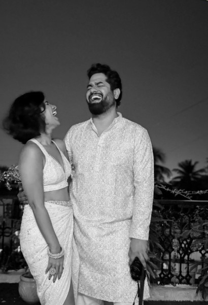 Aarti Samant and Manik, the founders of Sorted, laughing together on a rooftop
